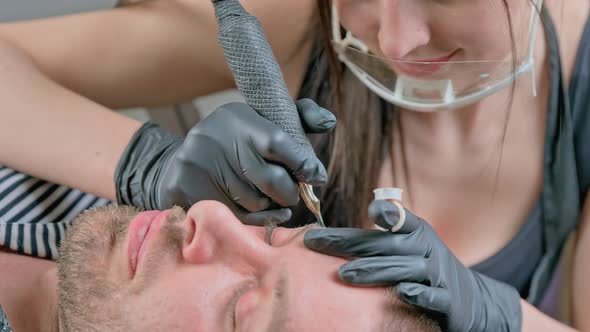 Master Beautician Does Eyebrow Tattoo