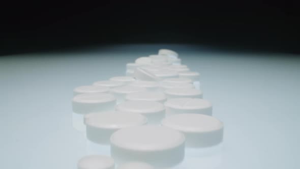 Studio Shot of Row of Medicine Tablets on White Table