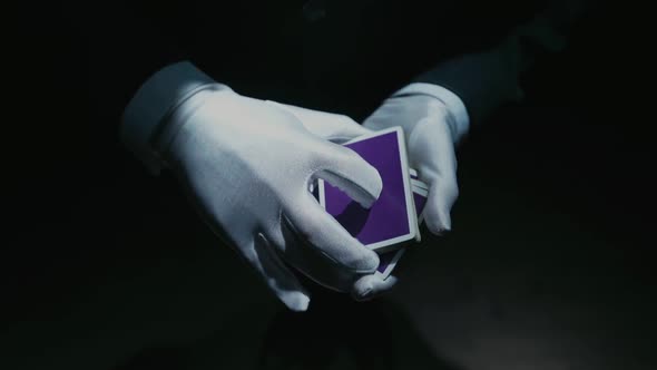 Close-up of a Suited Magician's Hands Performing Sleight of Hand Card Tricks. Slow Motion