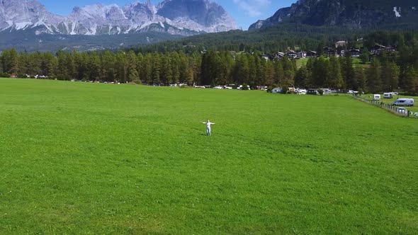 Camera Revolving Around Woman Enjoying the Beauty of Dolomites in the Background