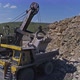 Excavator Loads Stones into a Dump Truck - VideoHive Item for Sale