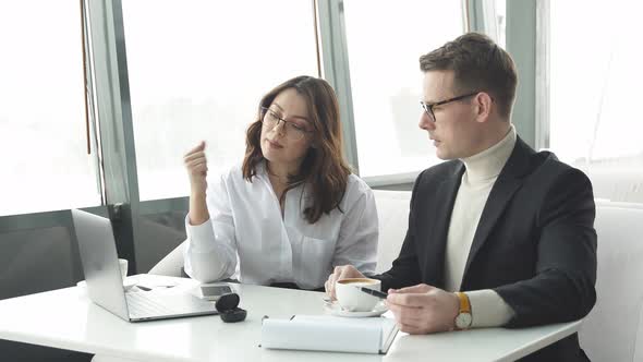 Pleasant Manager Sit Having Nice Talk with Male Businessman