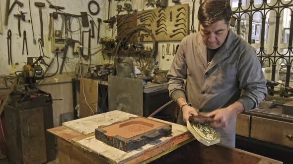 Professional artisan preparing sand mold