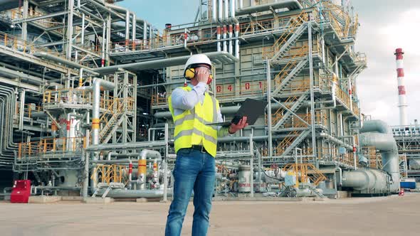 Petroleum Expert is Using Communication Gadgets at the Factory