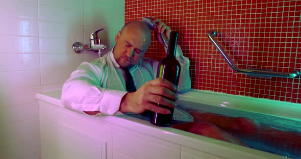 Portrait of a Bald Middle-aged Man, Sitting in a White Shirt and Tie in a Water-filled Bathroom