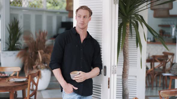 Handsome Man Drinks Delicious Coffee in Stylish Bright Cafe