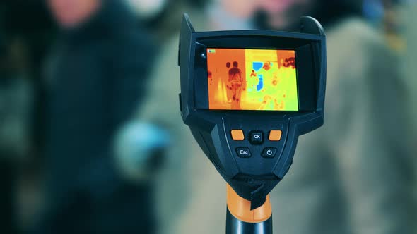 Thermographic Camera Is Scanning Walking People. Body Temperature Detecting, Covid-19 Prevention