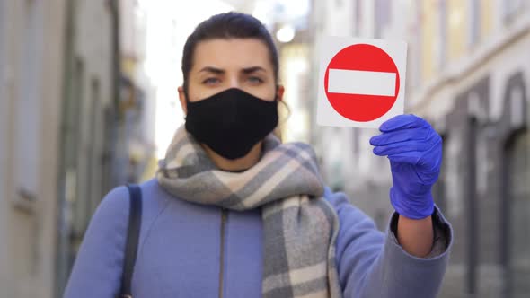 Woman in Face Mask with Stop Sign in City