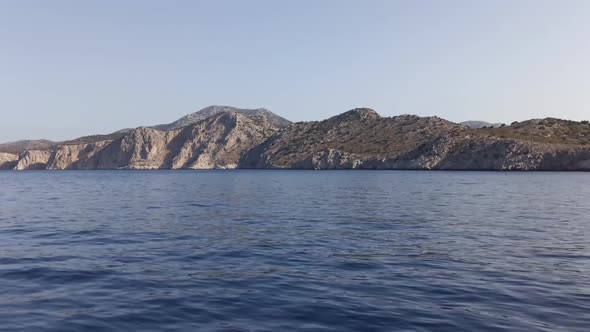 Rhodes, Greece: A Timelapse view of inhabited rusty hilly island from ship cruisin