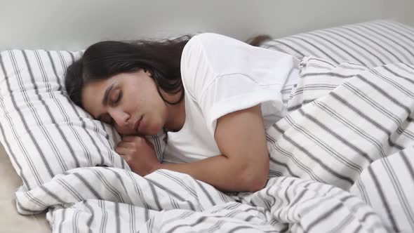 Lovely Woman Naps in Bed.