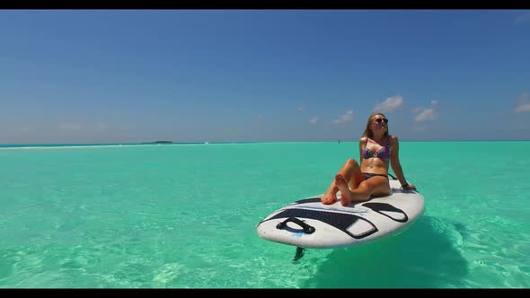 Ladies together happy and smiling on beautiful sea view beach adventure by aqua blue water with whit