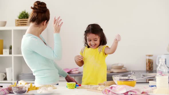 Mother and Daughter Having Fun at Home Kitchen