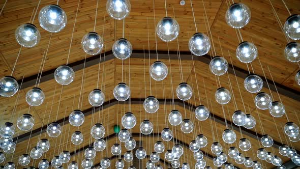 Luxury interior of glass light bulbs. Futuristic pendant lights of round shape. Many shiny balls on 