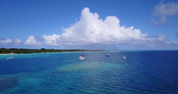 Tropical flying island view of a sandy white paradise beach and blue sea background in hi res 4K