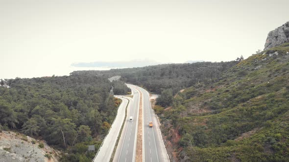Modern speedy highway road through mountains along beautiful coastline. 