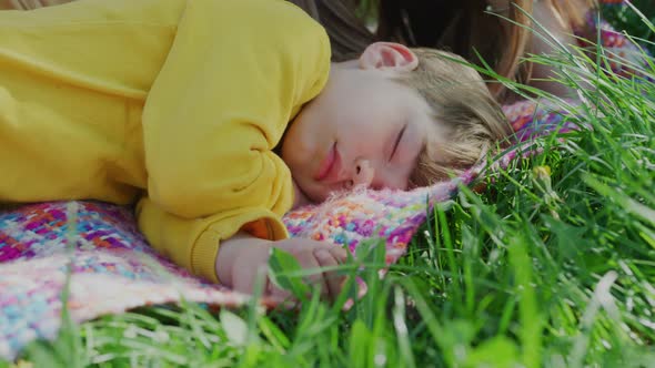 Boy napping outside on a blanket