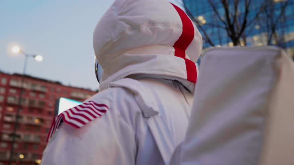 Spaceman standing in city, looking around