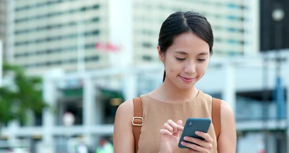 Woman use of mobile phone in city of Hong Kong