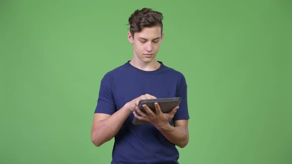 Young Handsome Teenage Boy Using Digital Tablet