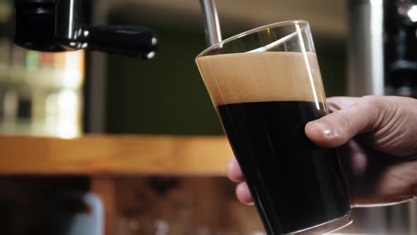 Barman Pouring Nitrogen Beer Into Glass Closeup