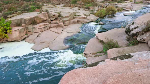 A Small Shining Stream Flows Among Smooth Wet and Dark Stones