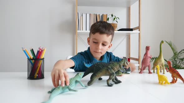 Funny Kid Playing with Dinosaurs at Home