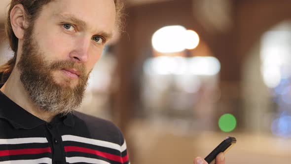 Closeup Caucasian Bearded Guy Serious Man Busy Working on Internet Holds Mobile Smartphone in His