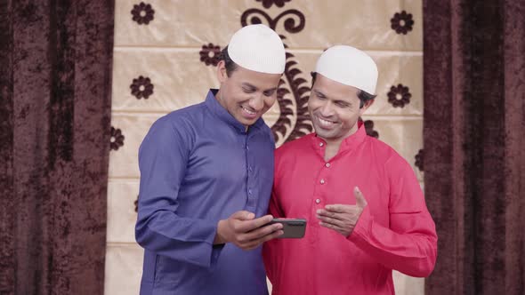 Muslim men watching a video on youtube