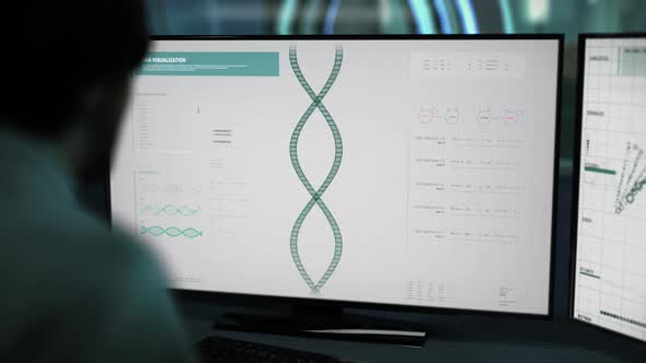 A Doctor is sitting behind the desk supervising the laboratory dna research alt