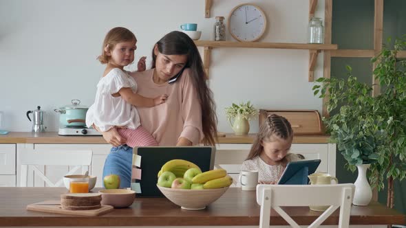 A Busy Mother Trying To Work Remotely