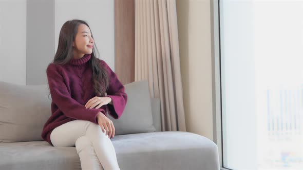 Asian woman sit on sofa and relax