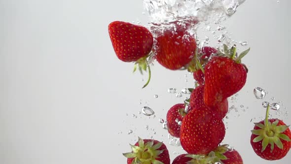 Ripe Strawberries Falling through the Water