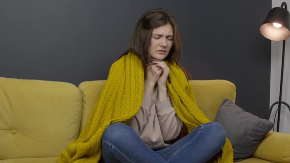 Sick Girl Sits on Yellow Sofa Coughing Suffering From Sore Throat of Cold Flu