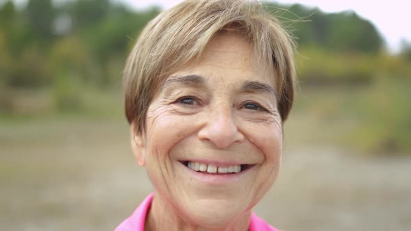 Happy Senior Woman Smiling on Camera Outdoor in the Woods  Real Elderly People Lifestyle