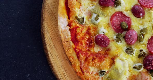 Baked pizza on wooden board