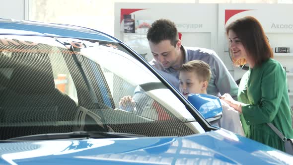Mother Father and Child Buying Car at Dealership a New Family Auto
