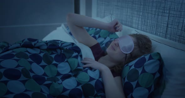 Young Woman Sleeps on Comfortable Bed in a Mask for Sleeping