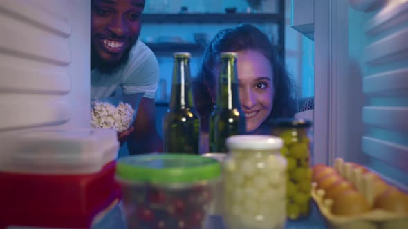 Multiethnic Couple Open Fridge and Take Cool Beer