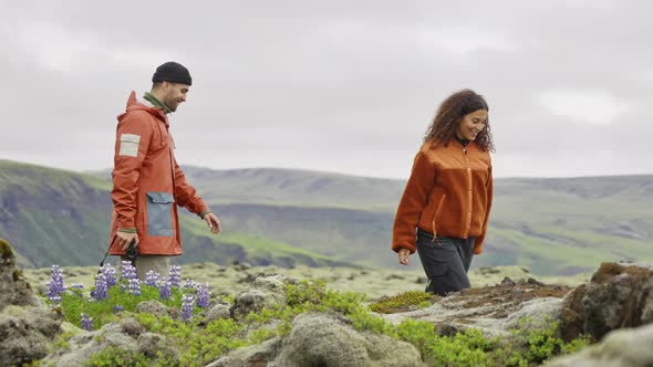 Couple Hiking In Rocky Moss Covered Landscape