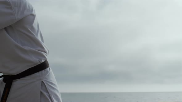 Sporty Man Practicing Karate Fighting on Beach