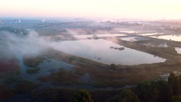 Aerial Drone View Flight Over Lakes and Fog Above Them on Early Summer Morning