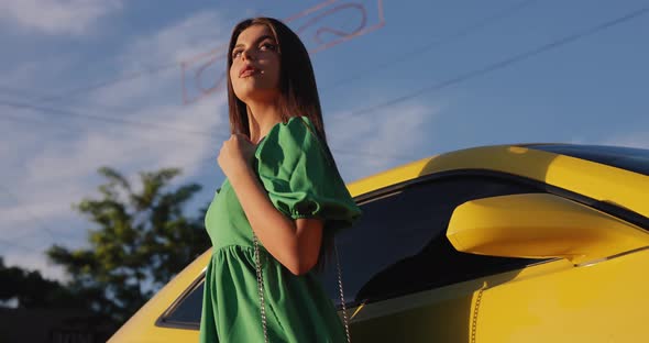 Beautiful Woman Posing Near a Yellow Luxury Car