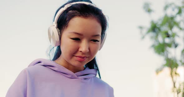 Asian Woman Freelancer Outdoors Working on Laptop alt