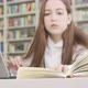 Selective Focus on a Book of a Teen Student Girl at the Library - VideoHive Item for Sale
