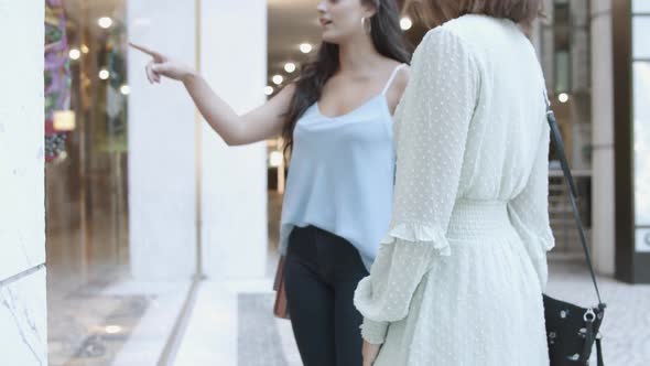 Unrecognizable Women Standing Near Shop-window