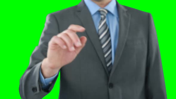 Mid section of businessman using digital screen