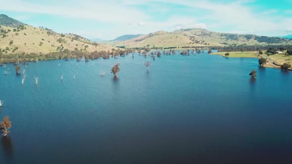 Rising aerial footage of the swollen floodplains of the Mitta Mitta River near where it enters Lake