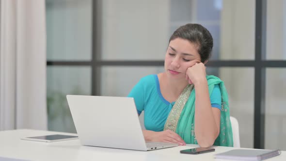 Indian Woman Taking Nap While Sitting in Office with Laptop