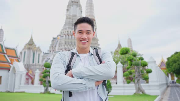 Portrait of Asian attractive man backpacker travel in beautiful city.