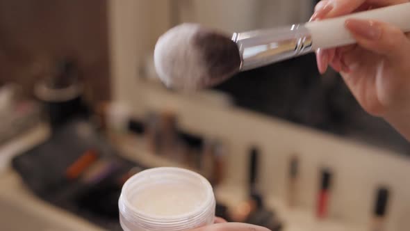 Closeup of a Makeup Artist Holding in Hands Brush and Powder